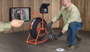 Man Performing a Mainline Sewer Repair in Yukon