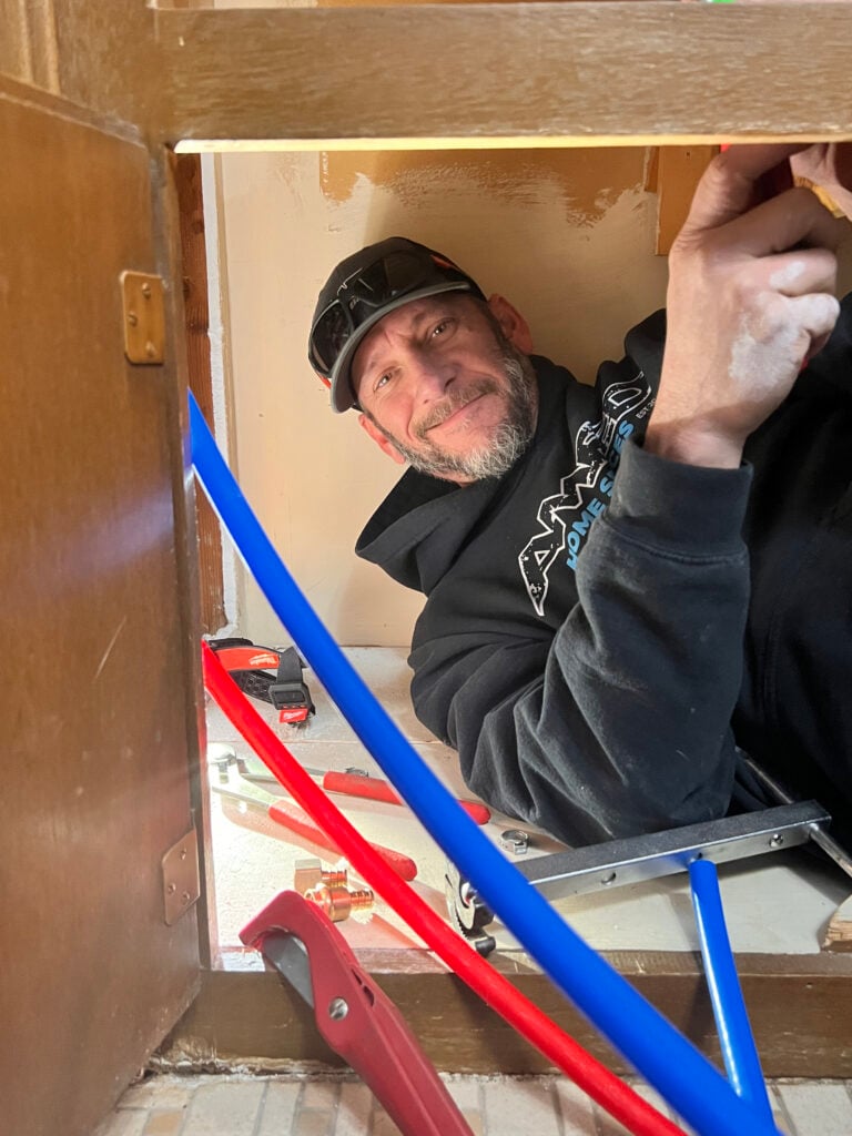 Amped plumber installing new PEX water lines in Oklahoma.