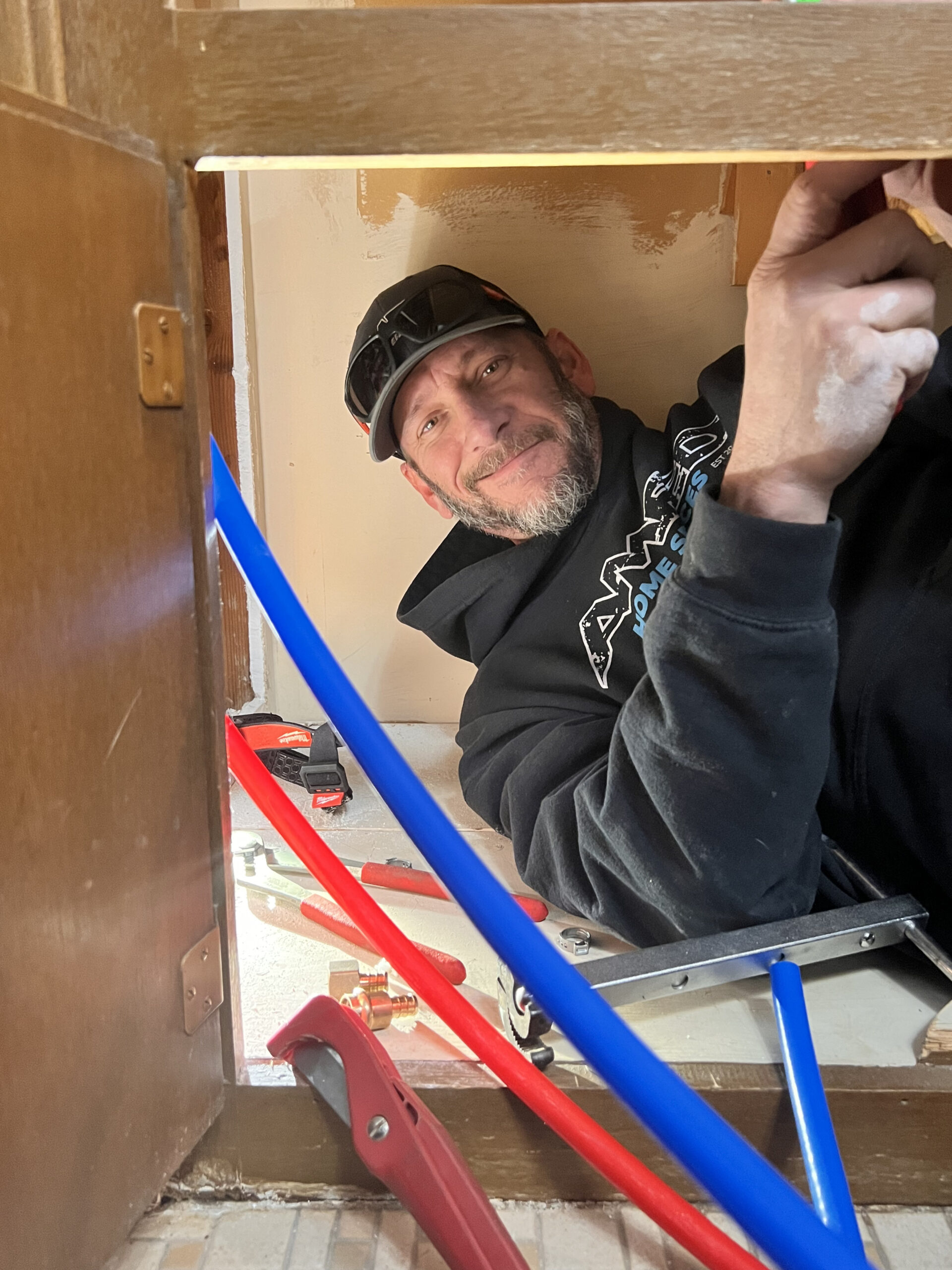 Amped plumber installing new PEX water lines in Oklahoma.