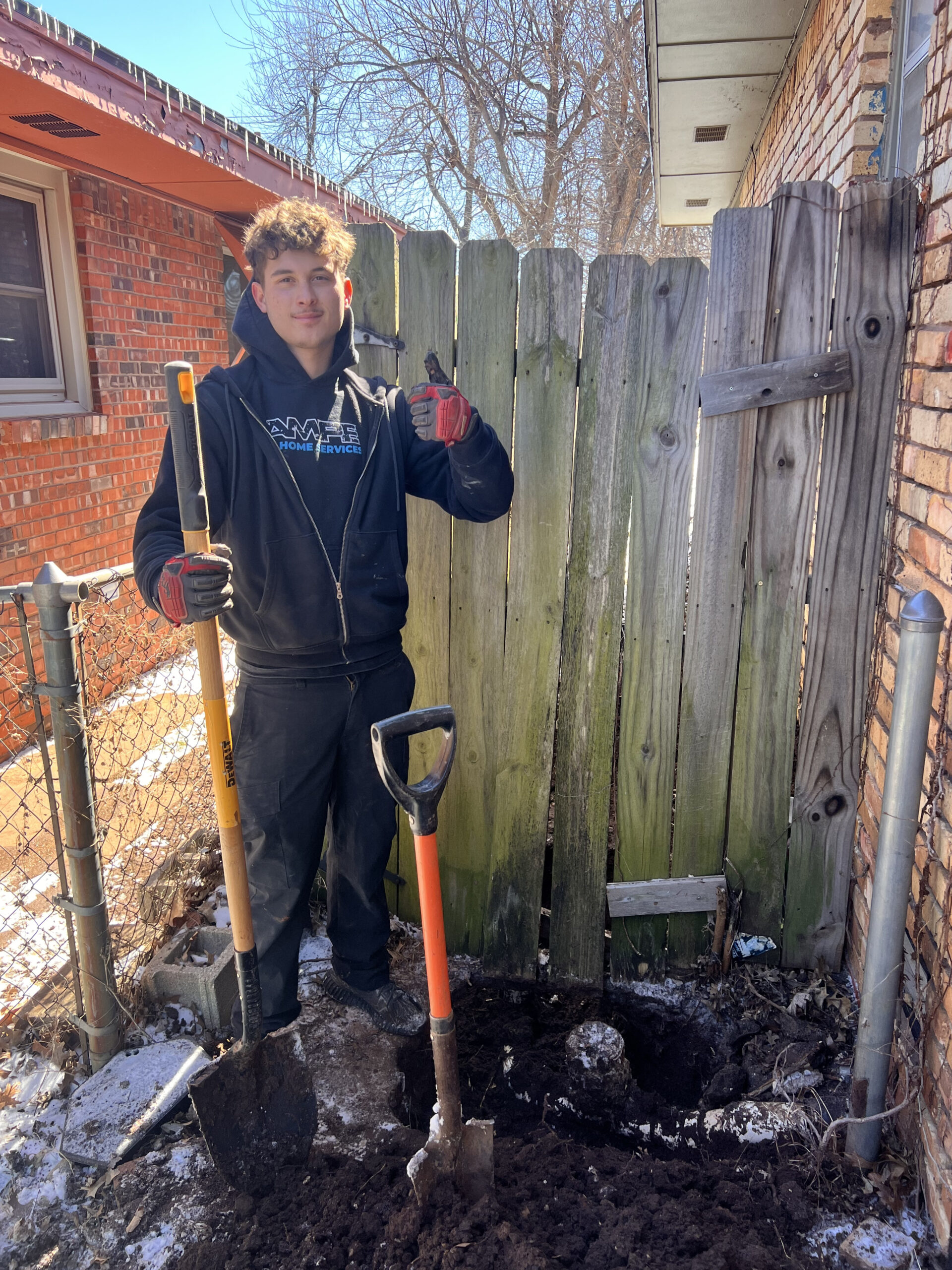 Amped technician preparing ground for sewer line repair in Oklahoma.