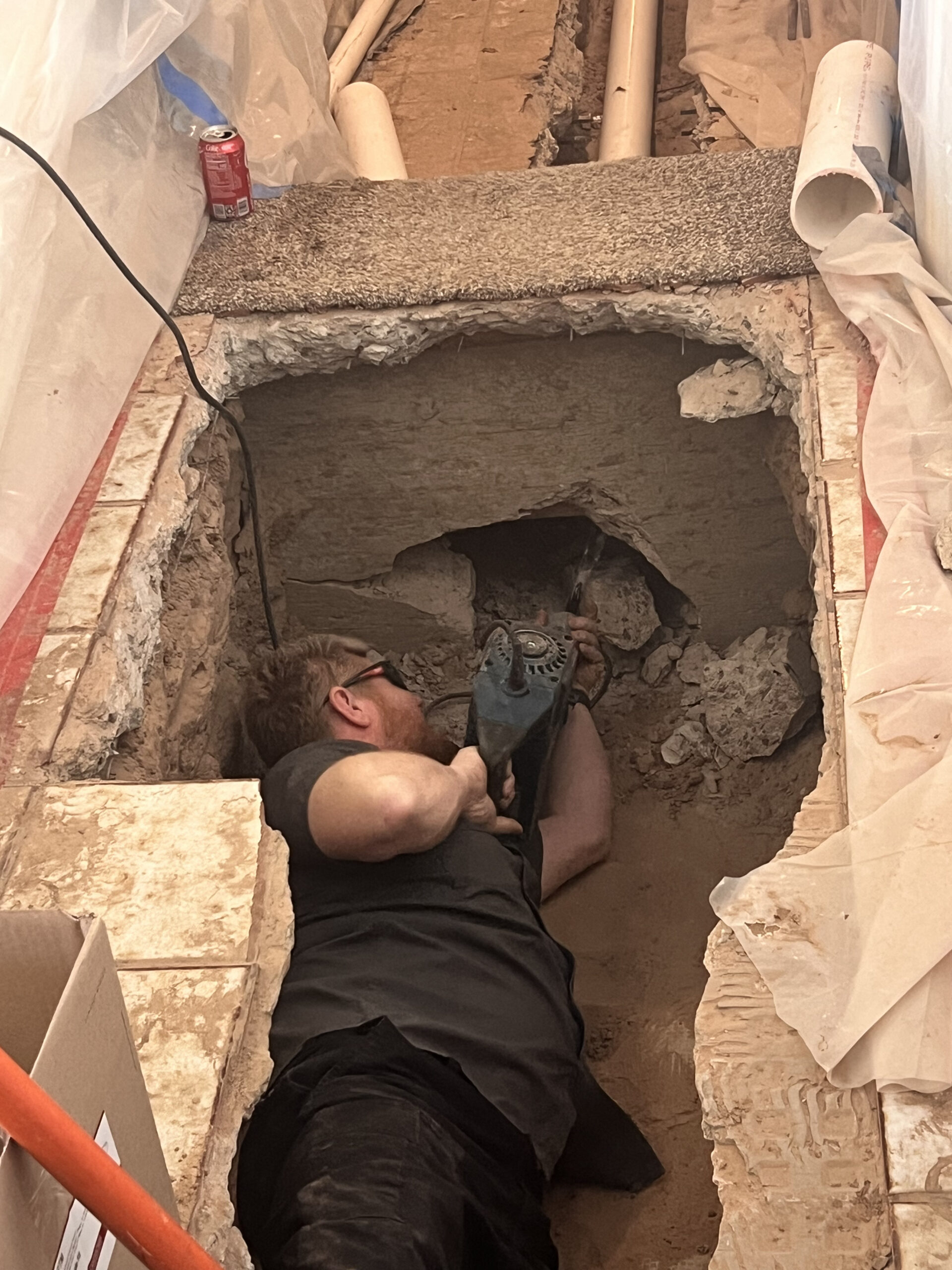 Amped plumber repairing underground plumbing in Oklahoma.