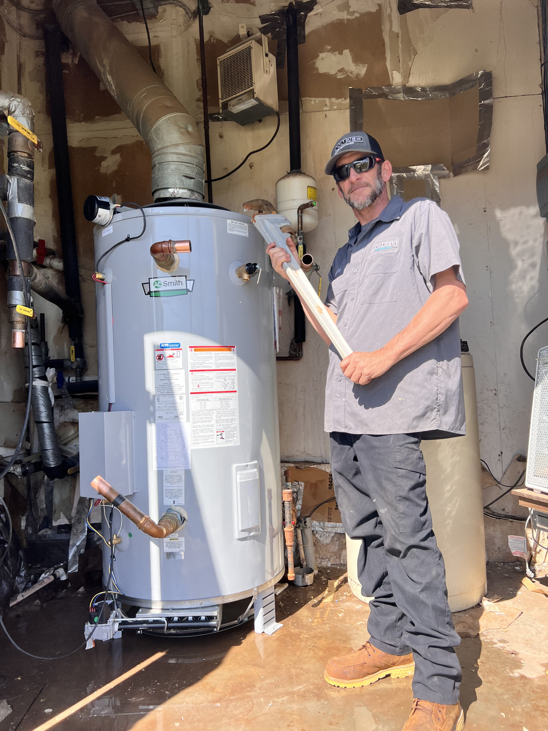 Amped plumber preparing water heater installation in Oklahoma.