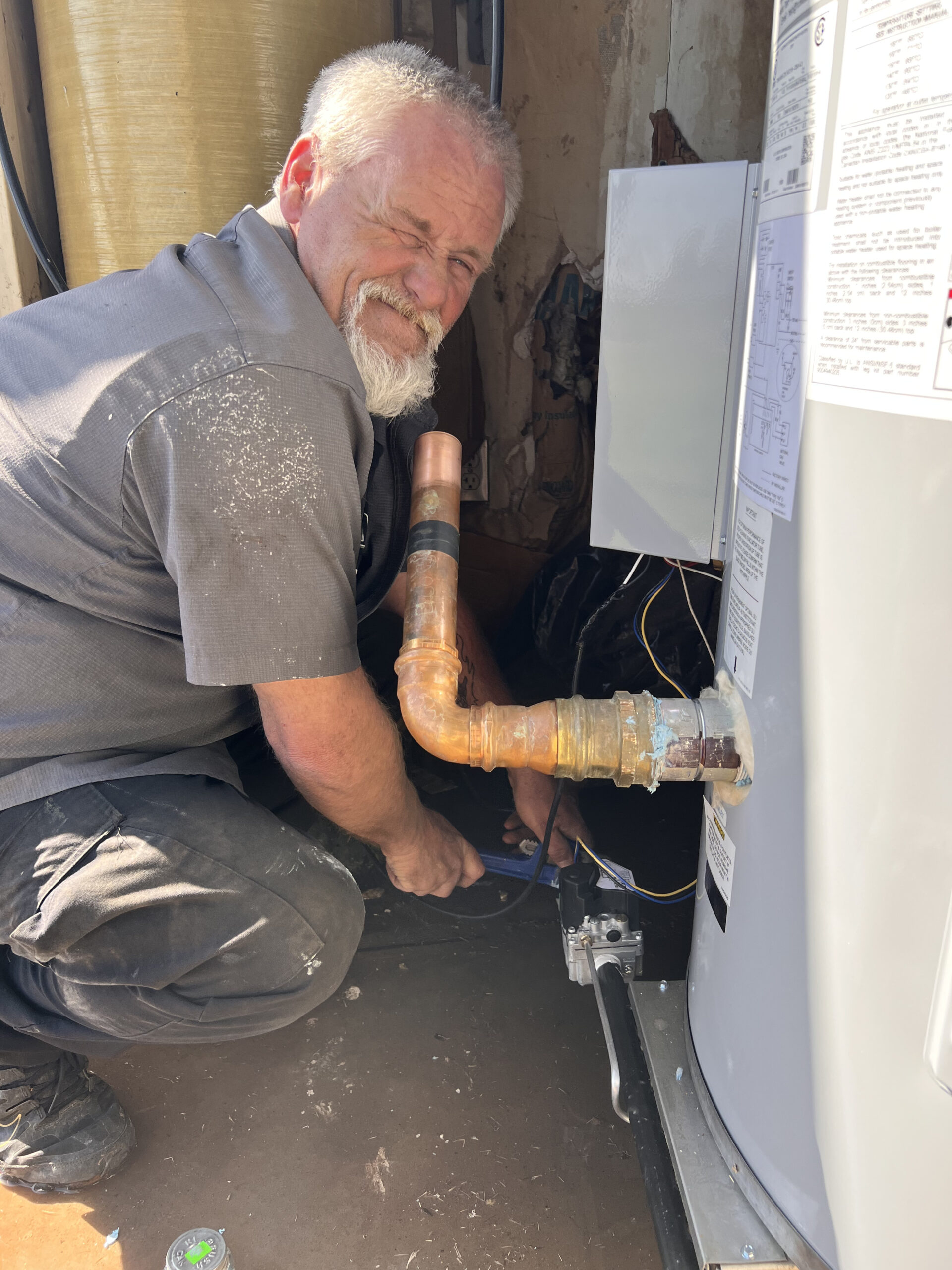 Amped plumber repairing corroded pipes in Oklahoma.