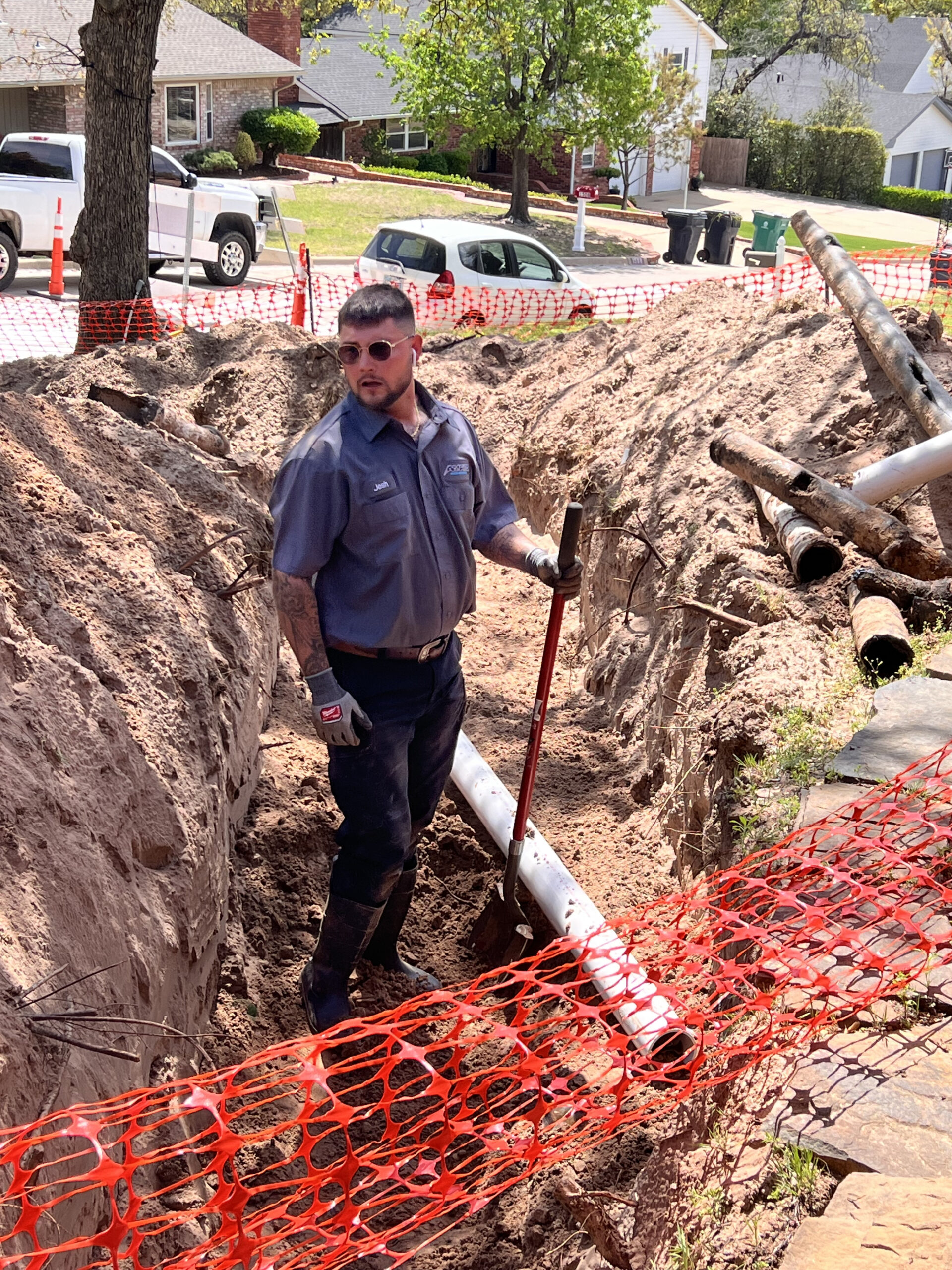 Amped plumber working on underground sewer line in Oklahoma.