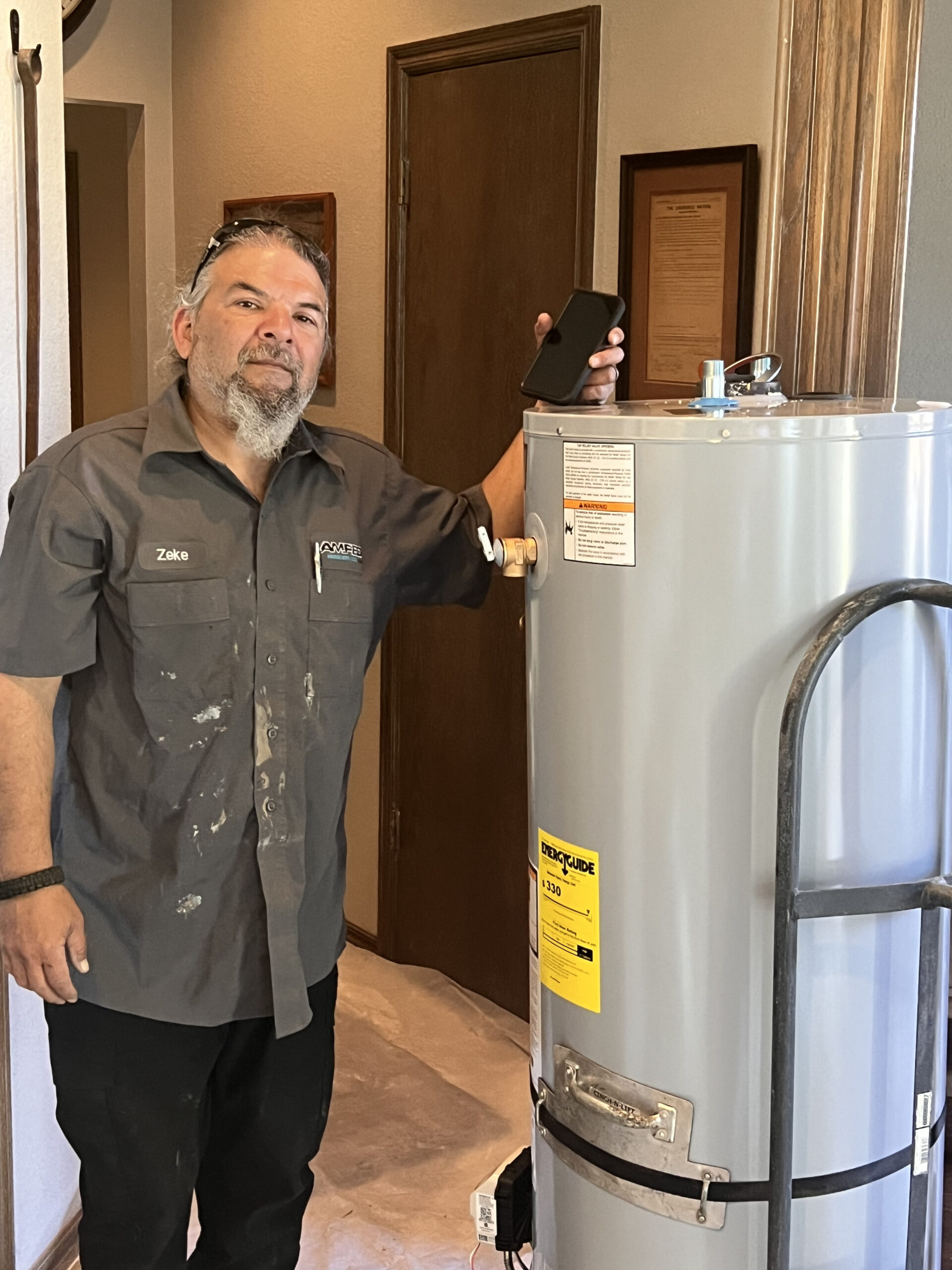 Amped plumber installing residential water heater in Oklahoma.