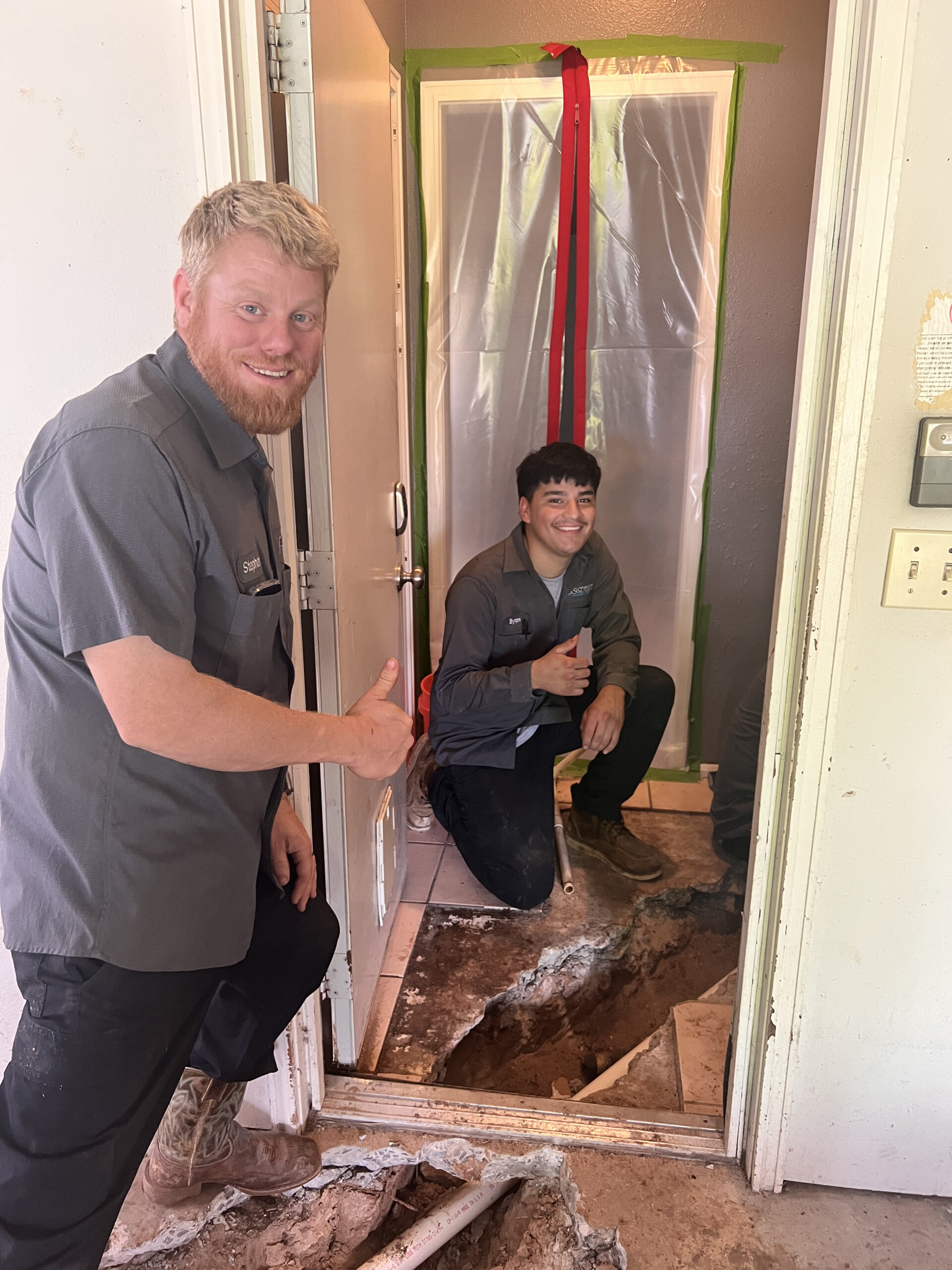 Amped plumbers preparing for plumbing repair inside Oklahoma home.