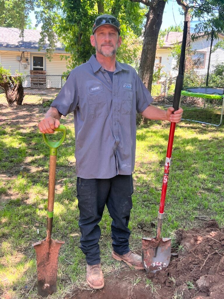Amped plumber preparing for outdoor excavation in Oklahoma.