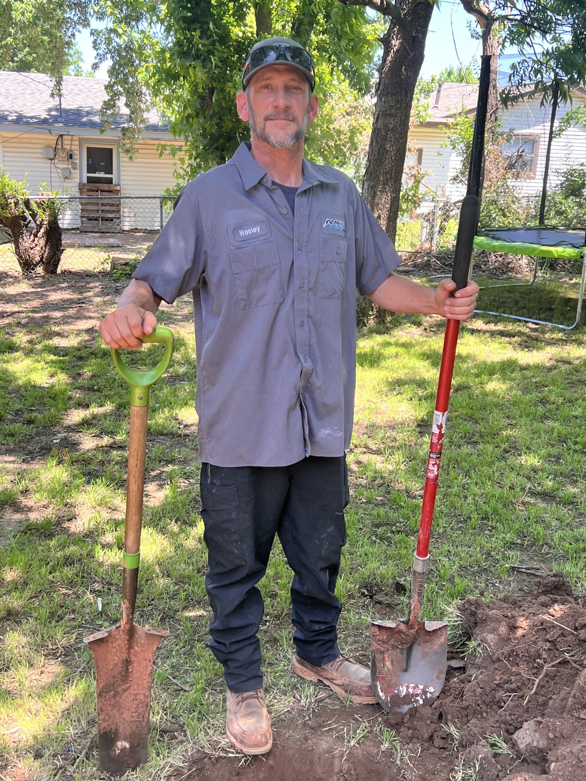 Amped plumber preparing for outdoor excavation in Oklahoma.