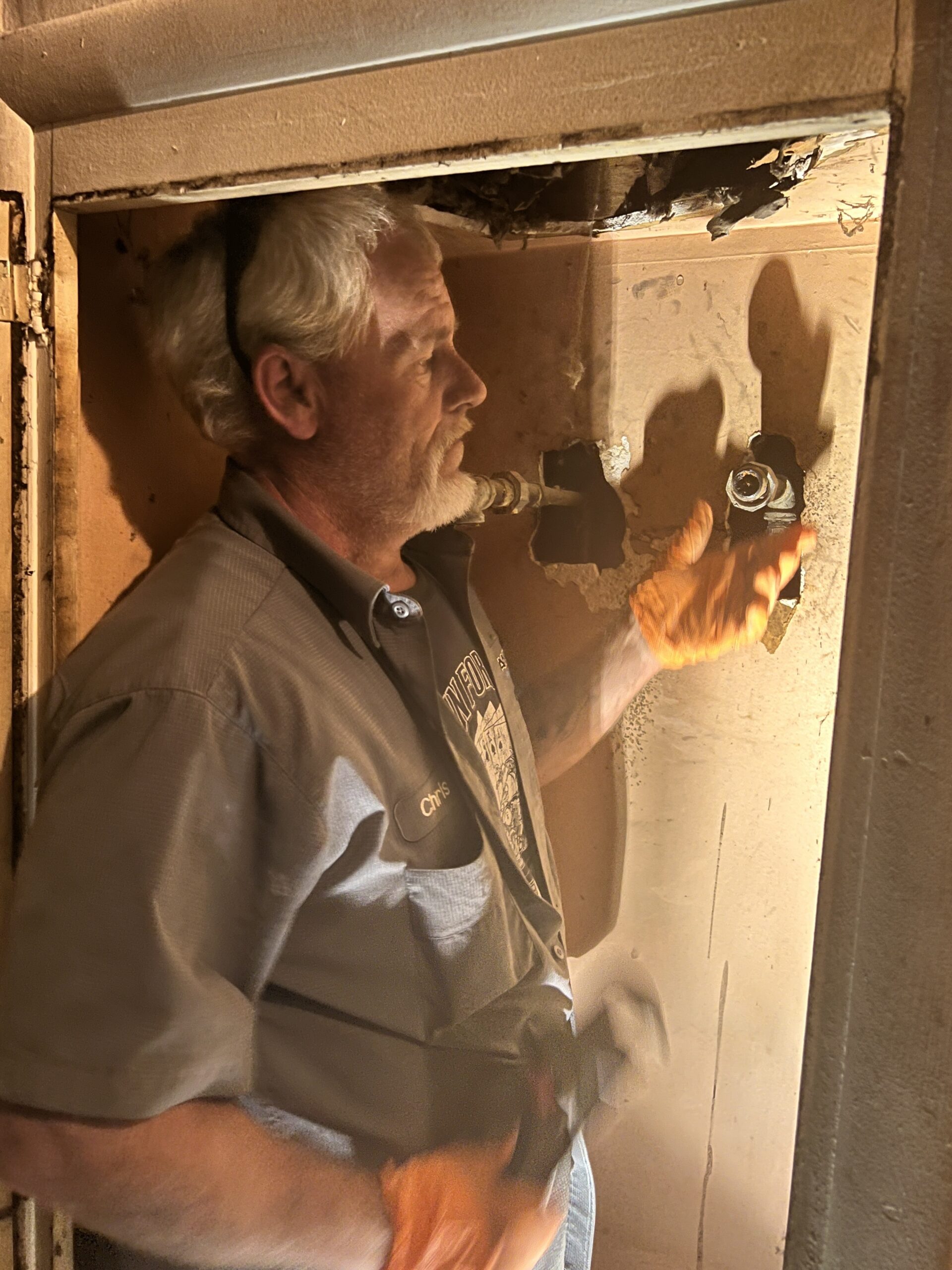 Amped plumber performing pipe installation indoors in Oklahoma.