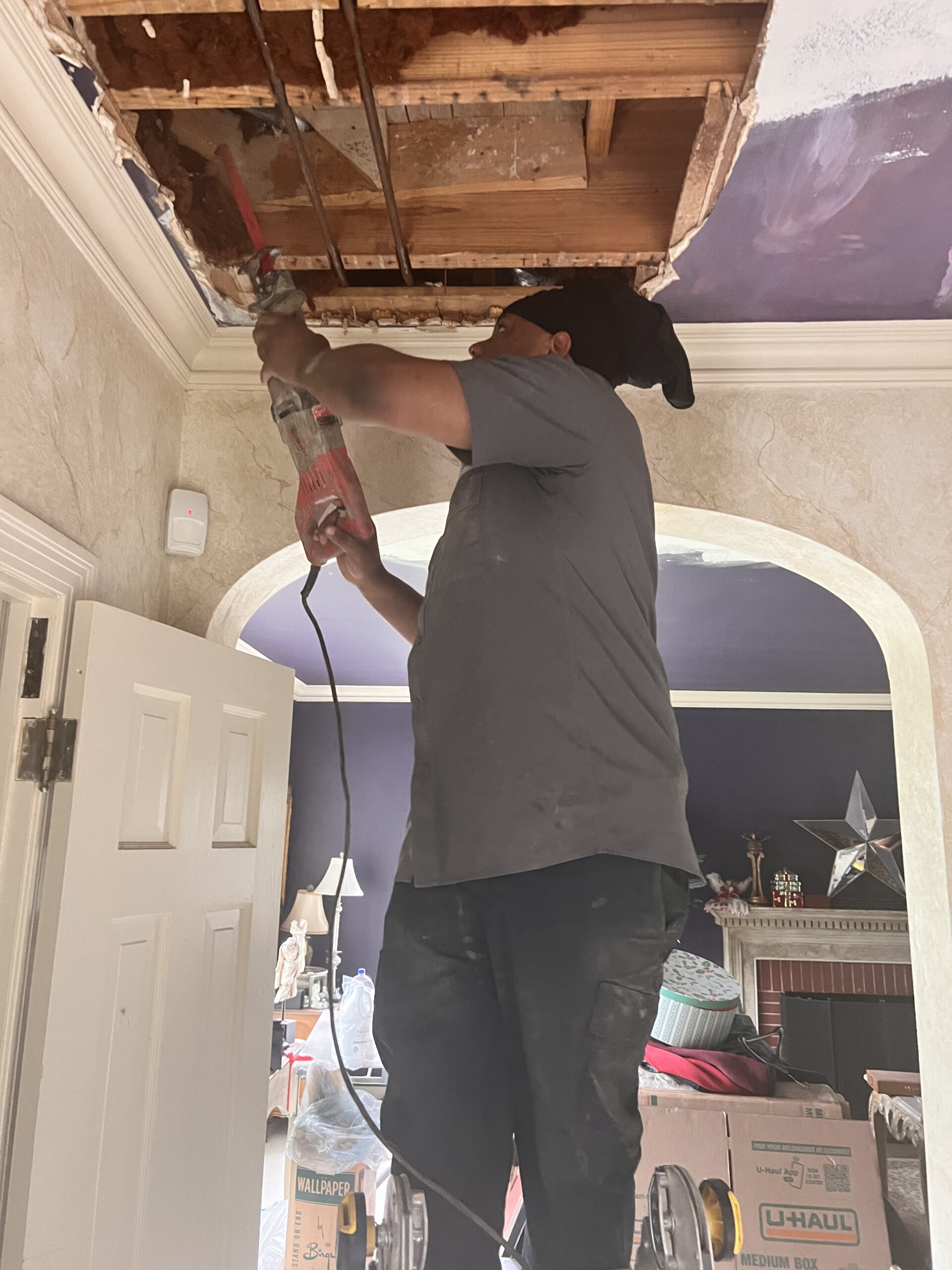 Amped plumber repairing ceiling pipe in Oklahoma.