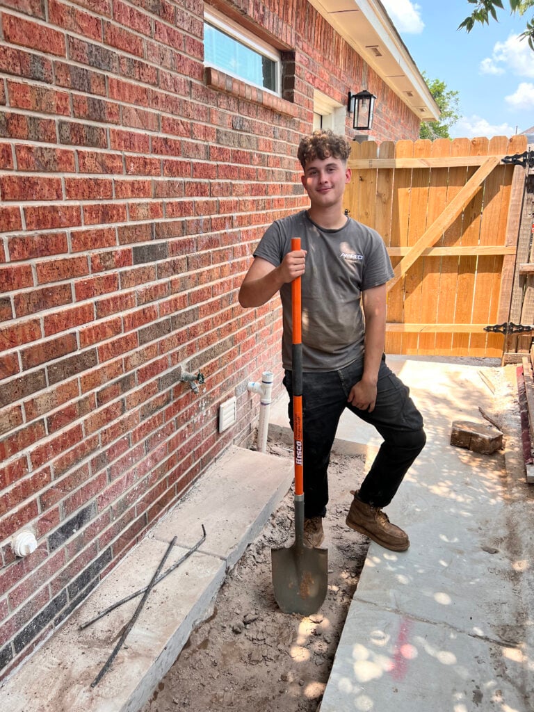 Amped plumber preparing for outdoor plumbing work in Oklahoma.