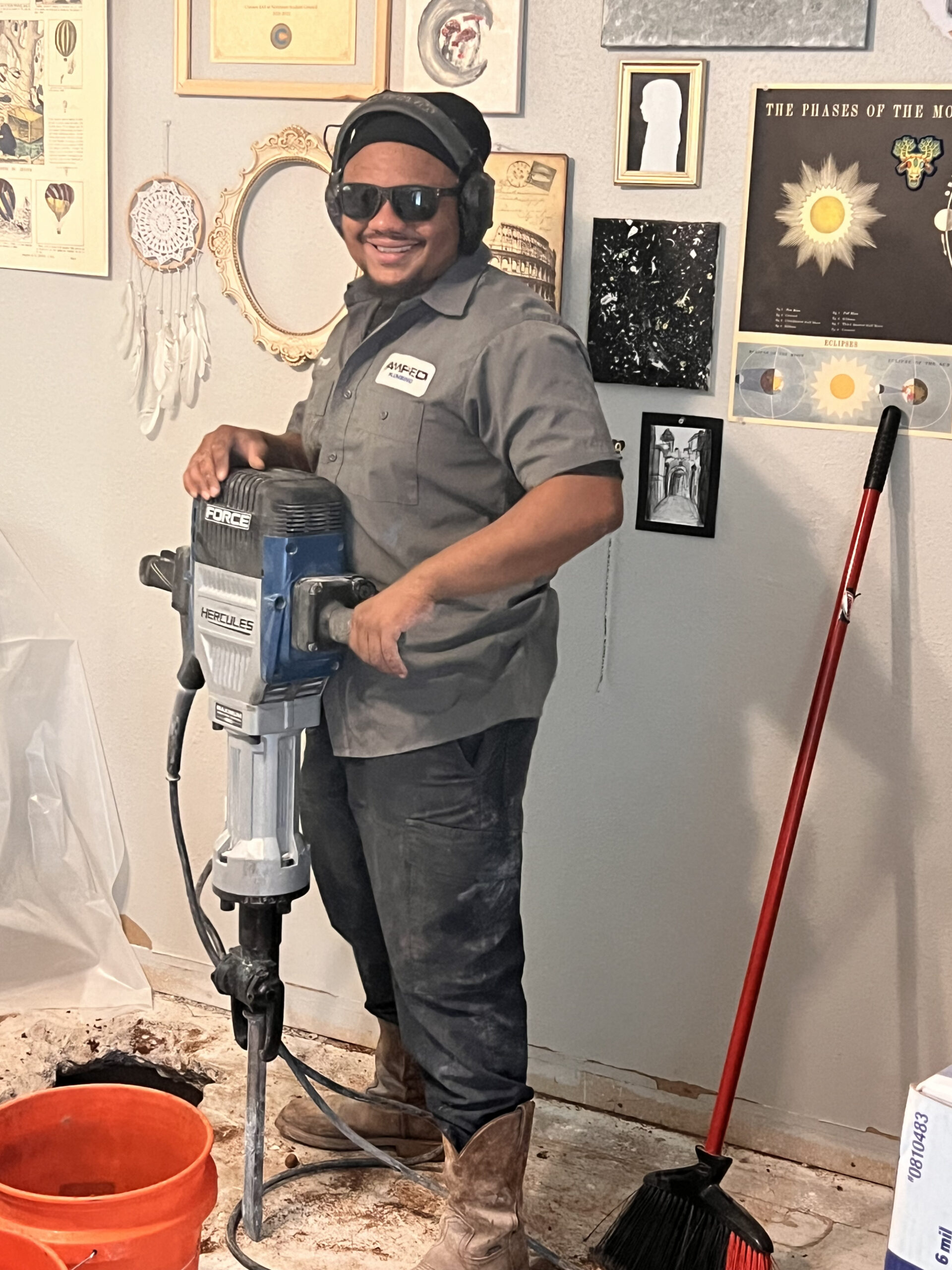 Amped plumber using jackhammer for slab repair in Oklahoma home.