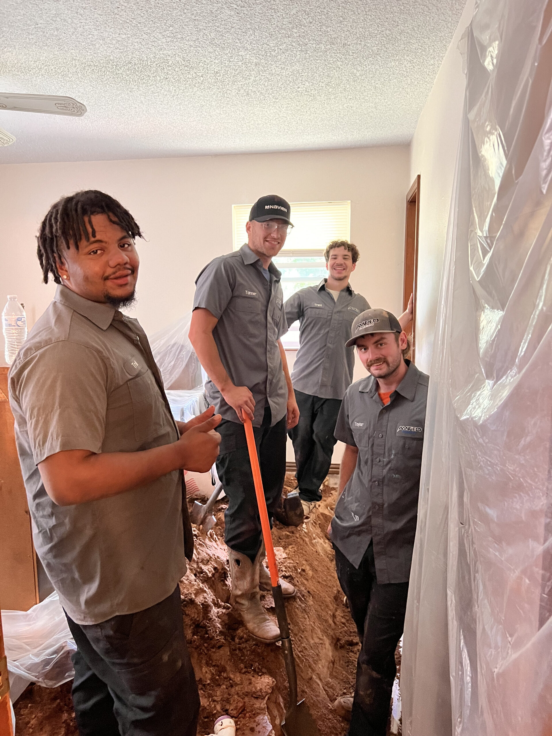 Amped plumbing crew repairing indoor plumbing in Oklahoma.