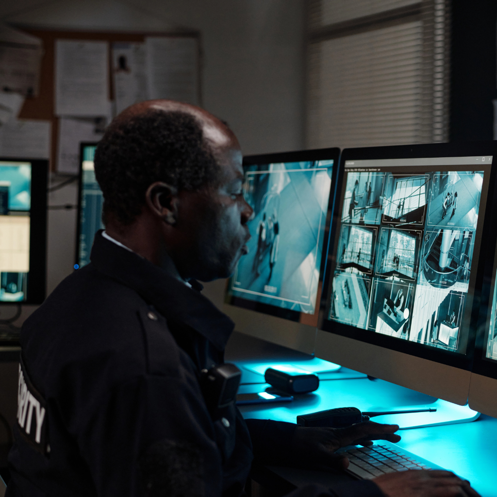 Security professional monitoring surveillance cameras in Oklahoma.