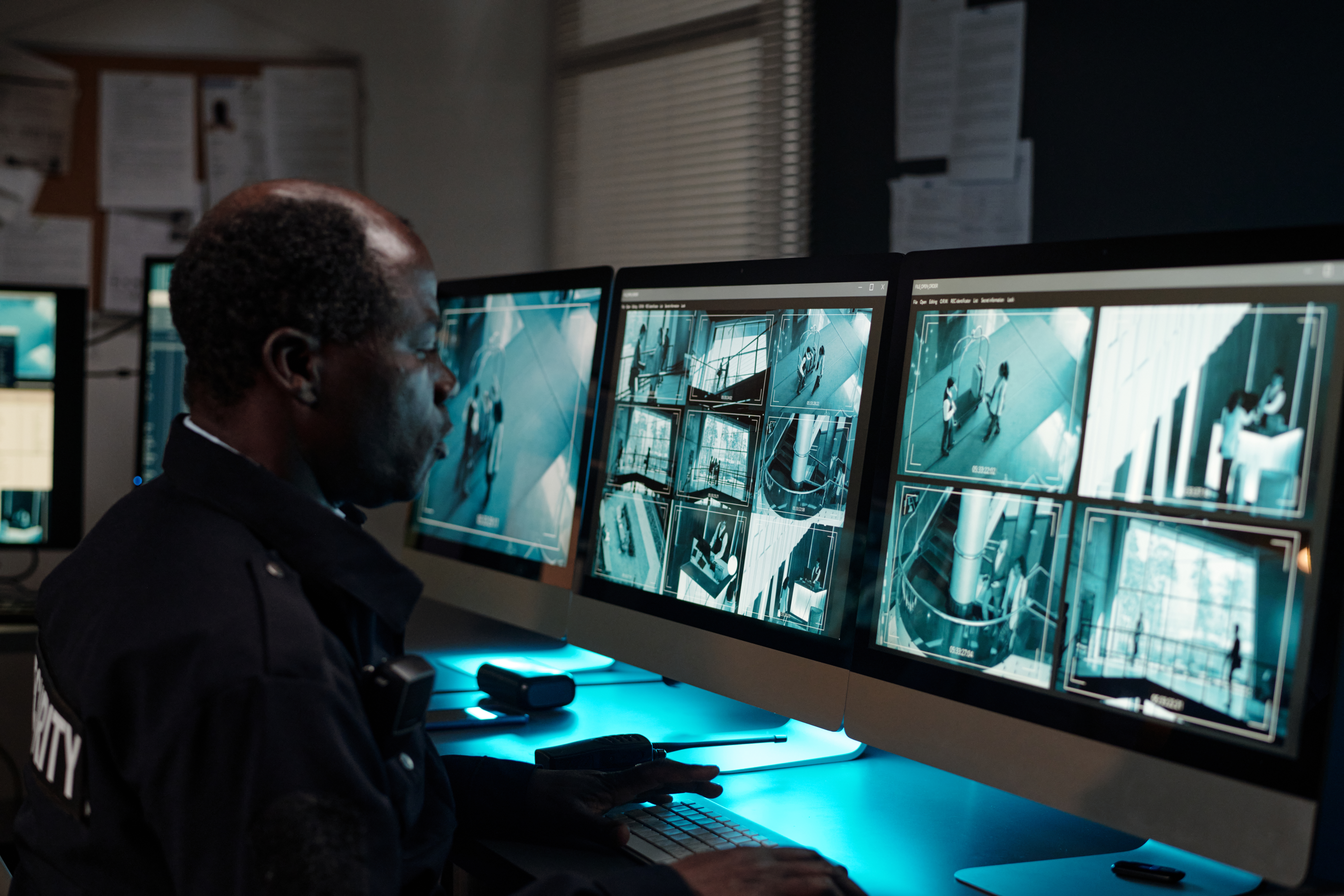 Security professional monitoring surveillance cameras in Oklahoma.