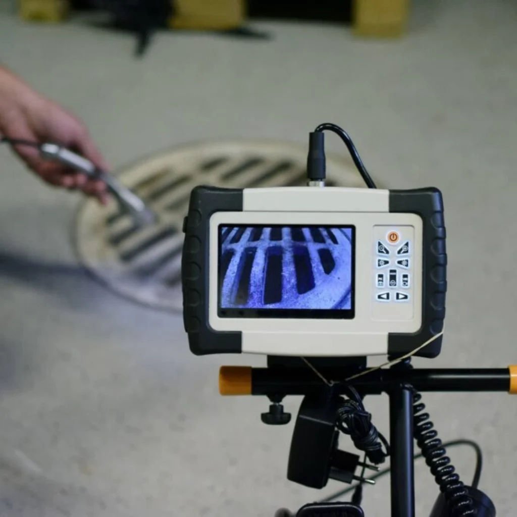 Drain inspection camera monitor showing a live view inside a plumbing line