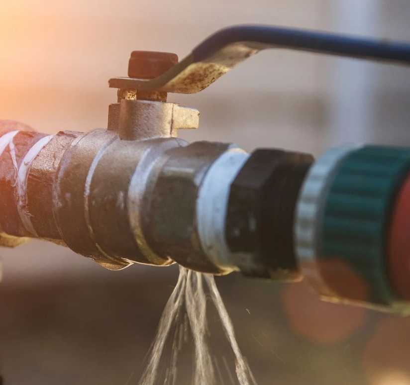 Water leaking from a plumbing valve and pipe connection
