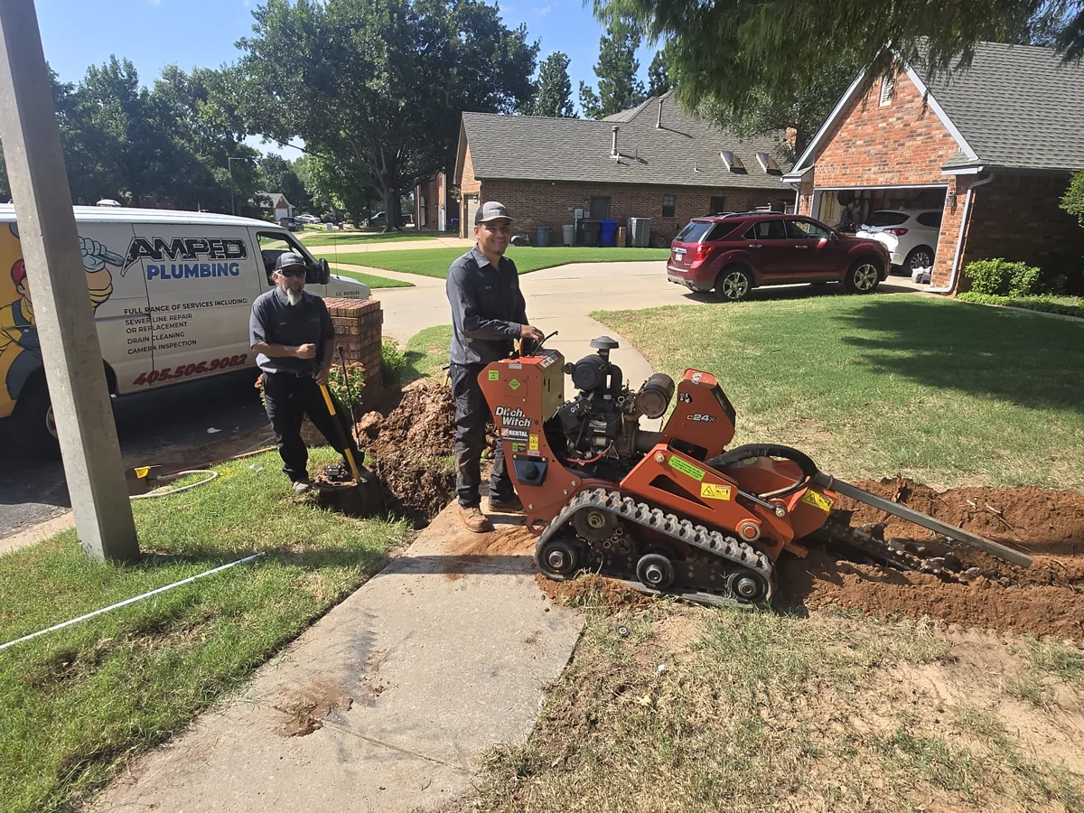 Amped crew with a trencher during front-yard water-line replacement
