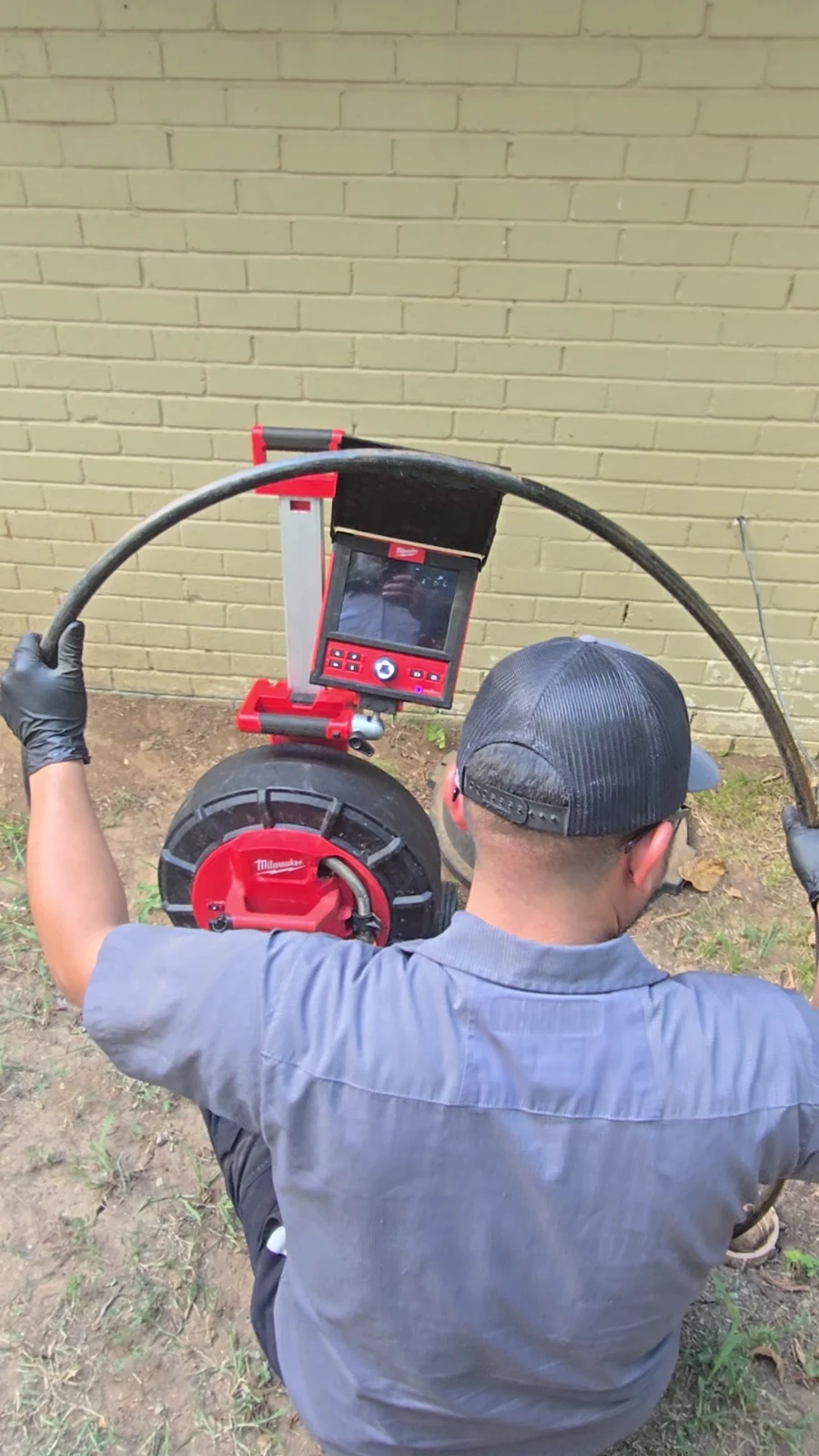 Amped technician operating sewer inspection camera equipment