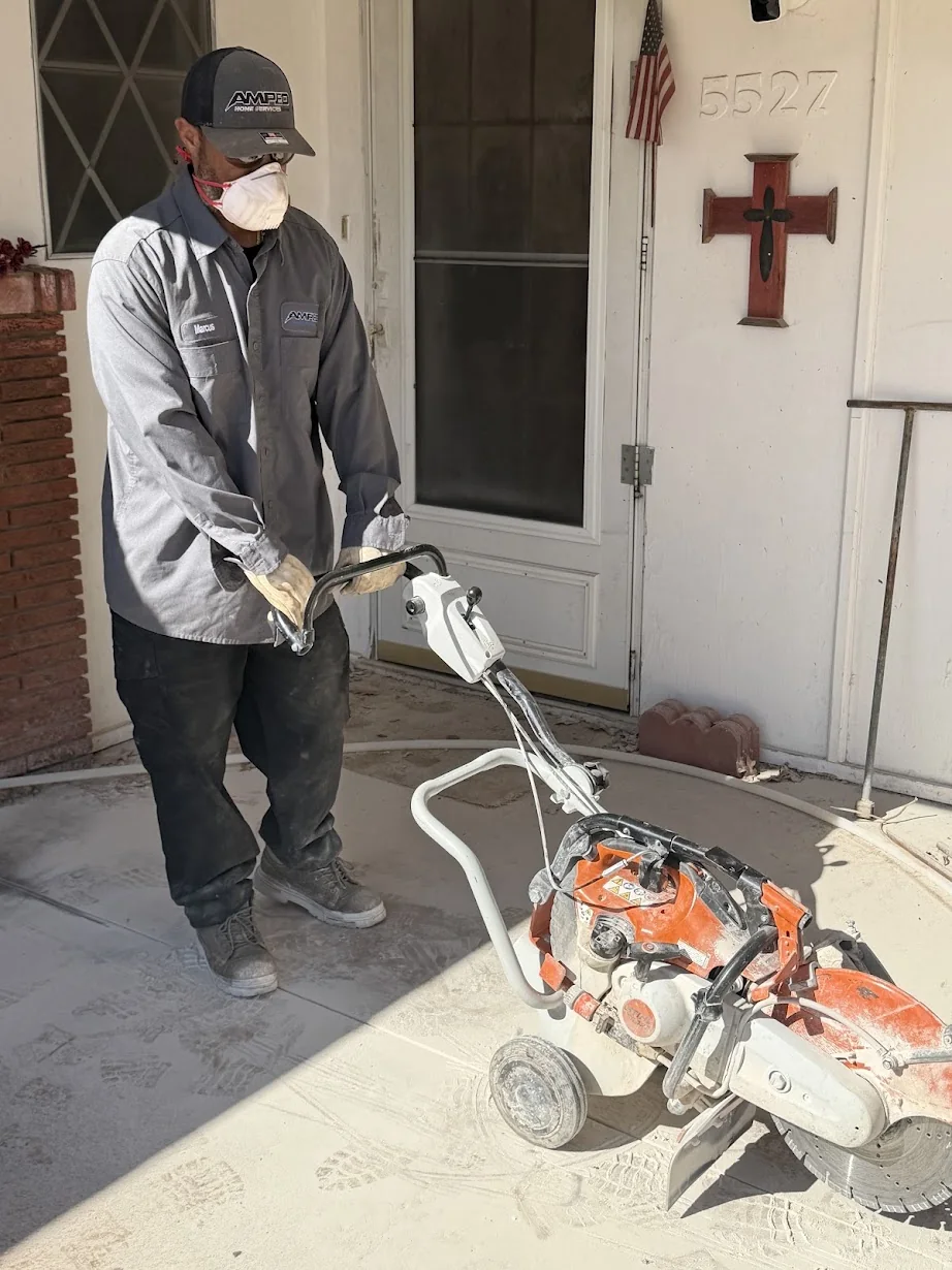 Marcus from Amped with concrete-cutting equipment on a slab-leak job