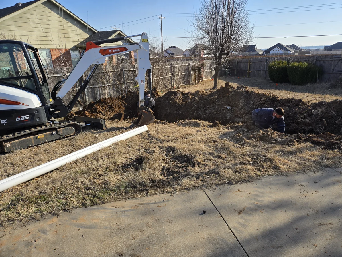 Amped technician and excavator working on a yard sewer line