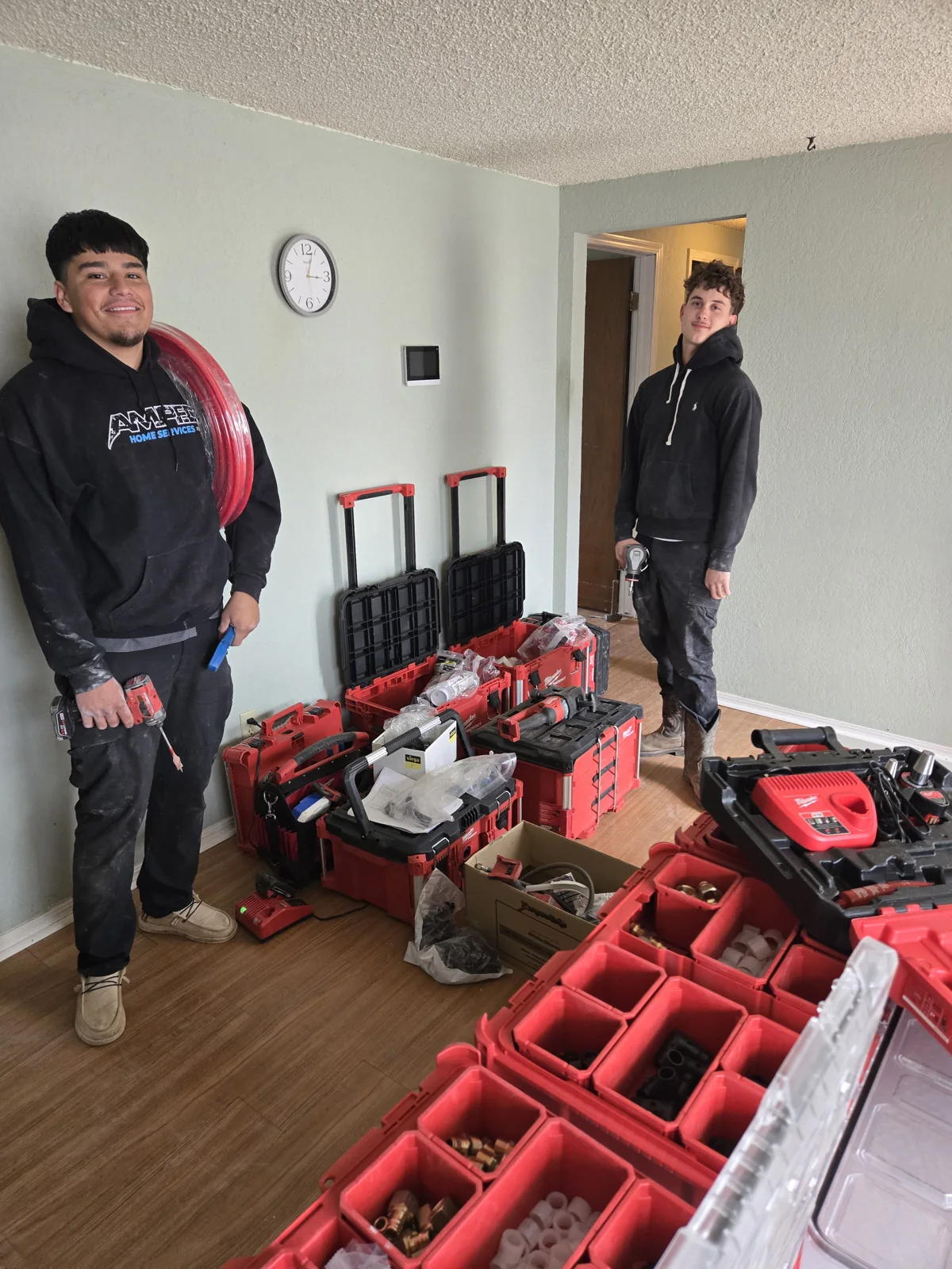Amped team with water piping and tools for a whole-house water repipe